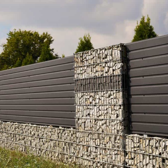 House fence with an interesting use of gabions and steel panels.